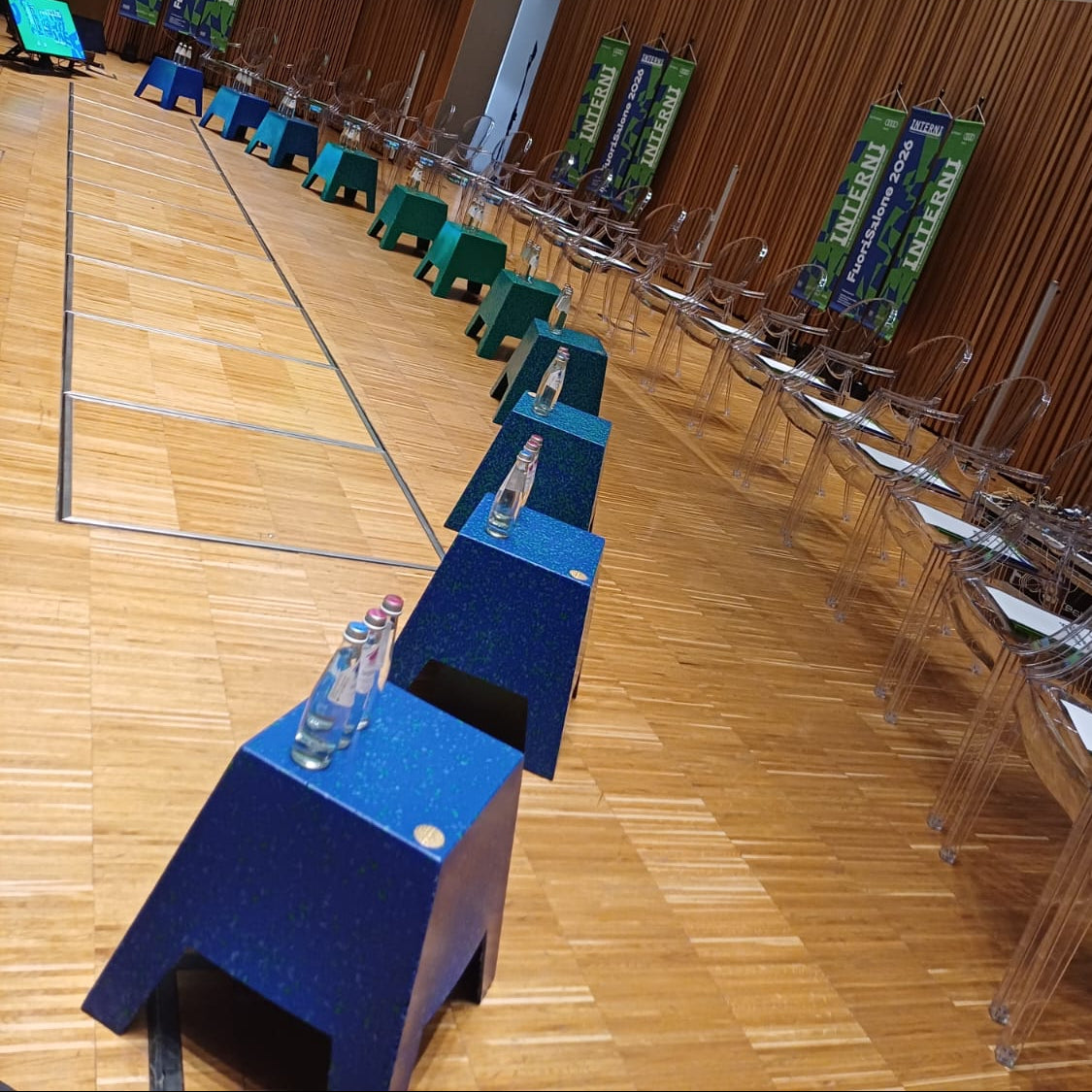 A large indoor auditorium, conference hall rows of ecopixel TAPER chairs, blue and green tables. Courtesy of INTEERI Statale di Milano