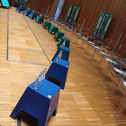 A large indoor auditorium, conference hall rows of ecopixel TAPER chairs, blue and green tables. Courtesy of INTEERI Statale di Milano