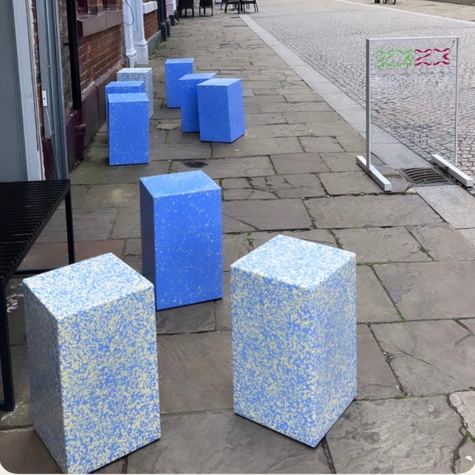 A street scene with several blue and white speckled cube stools made in ecopixel recycled plastic. Courtesy @2323Coffe Sheffield